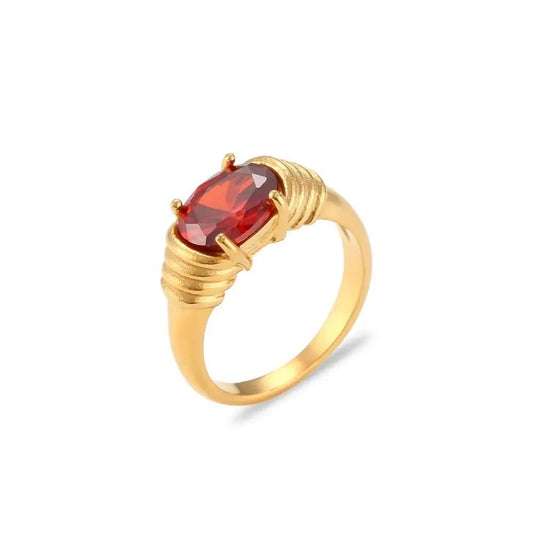 Gold Gemstone Ring with a red gemstone on a white background