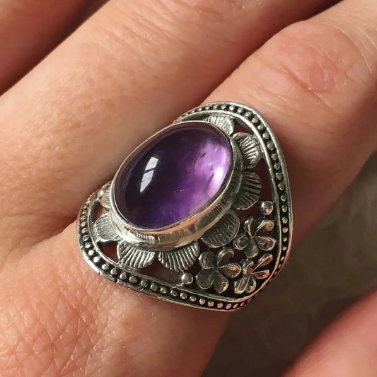 Person Wearing Oval Amethyst Ring